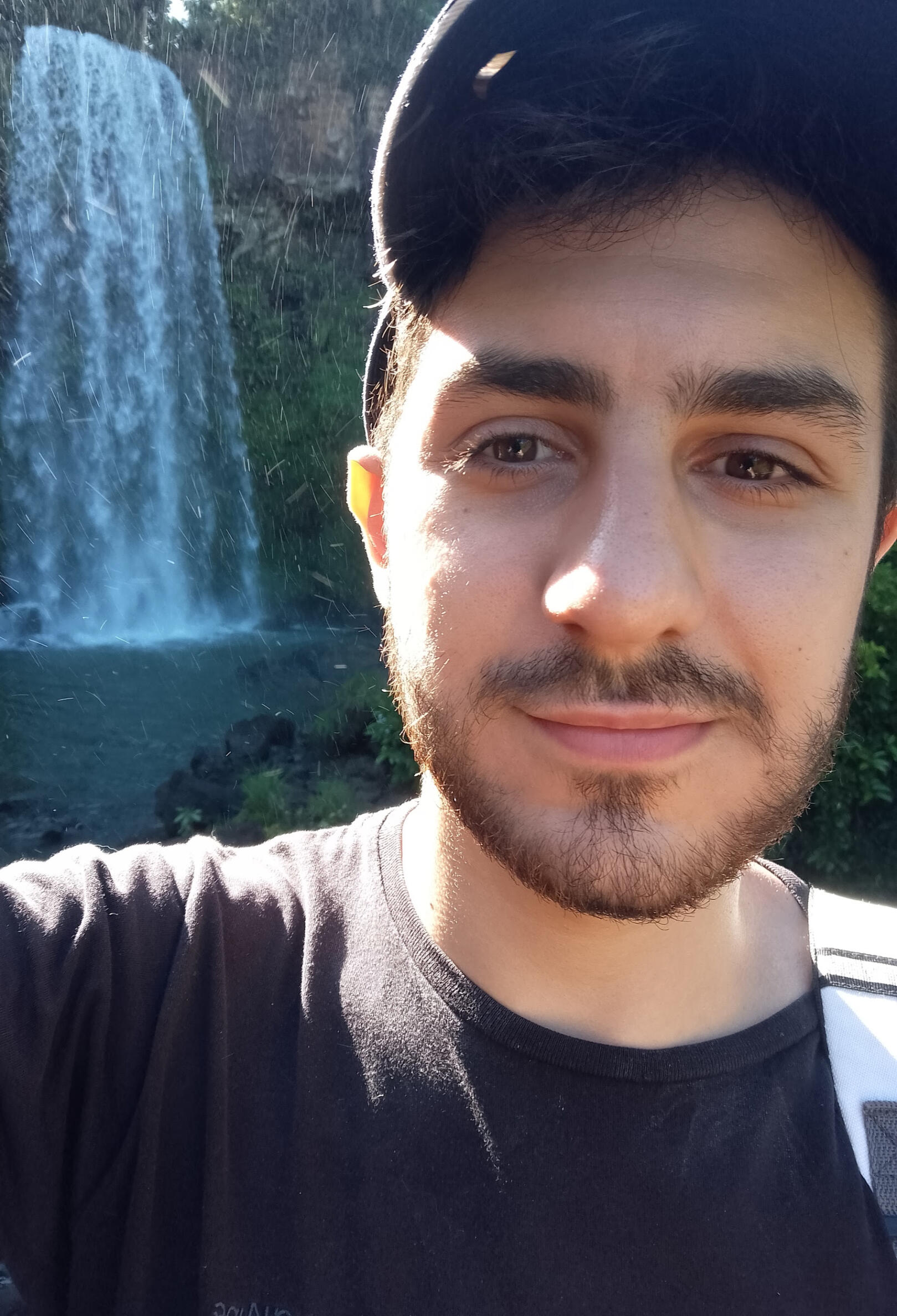 Santi Montali in front of a waterfall