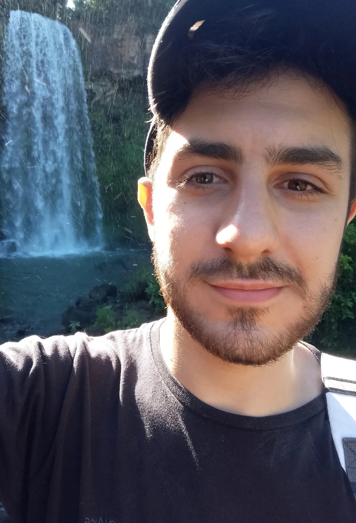Santi Montali in front of a waterfall
